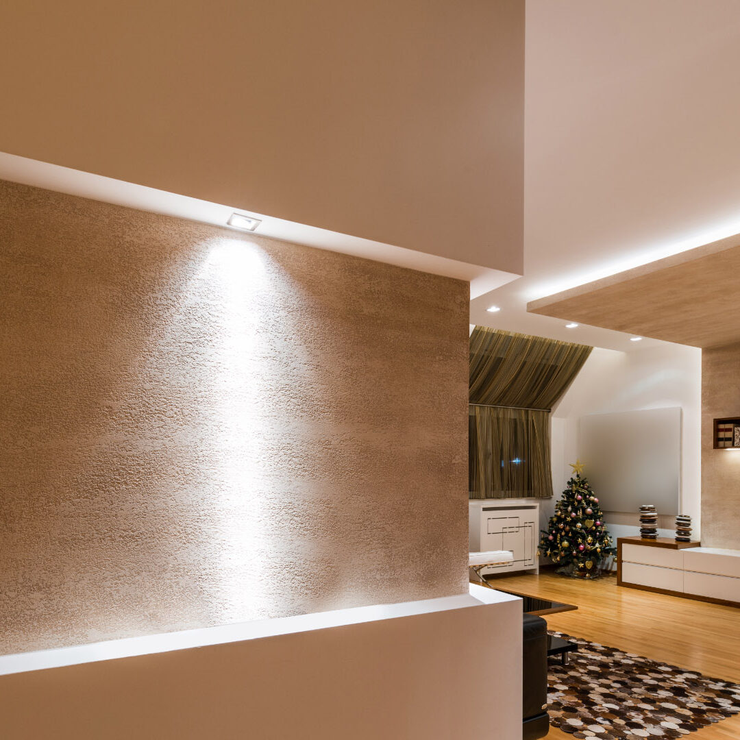 Großes Wohnzimmer mit einer Kombination aus direktem und indirektem Licht, klar und einladend